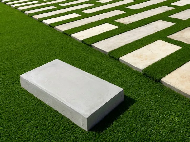 Rectangular paving slabs laid on grass